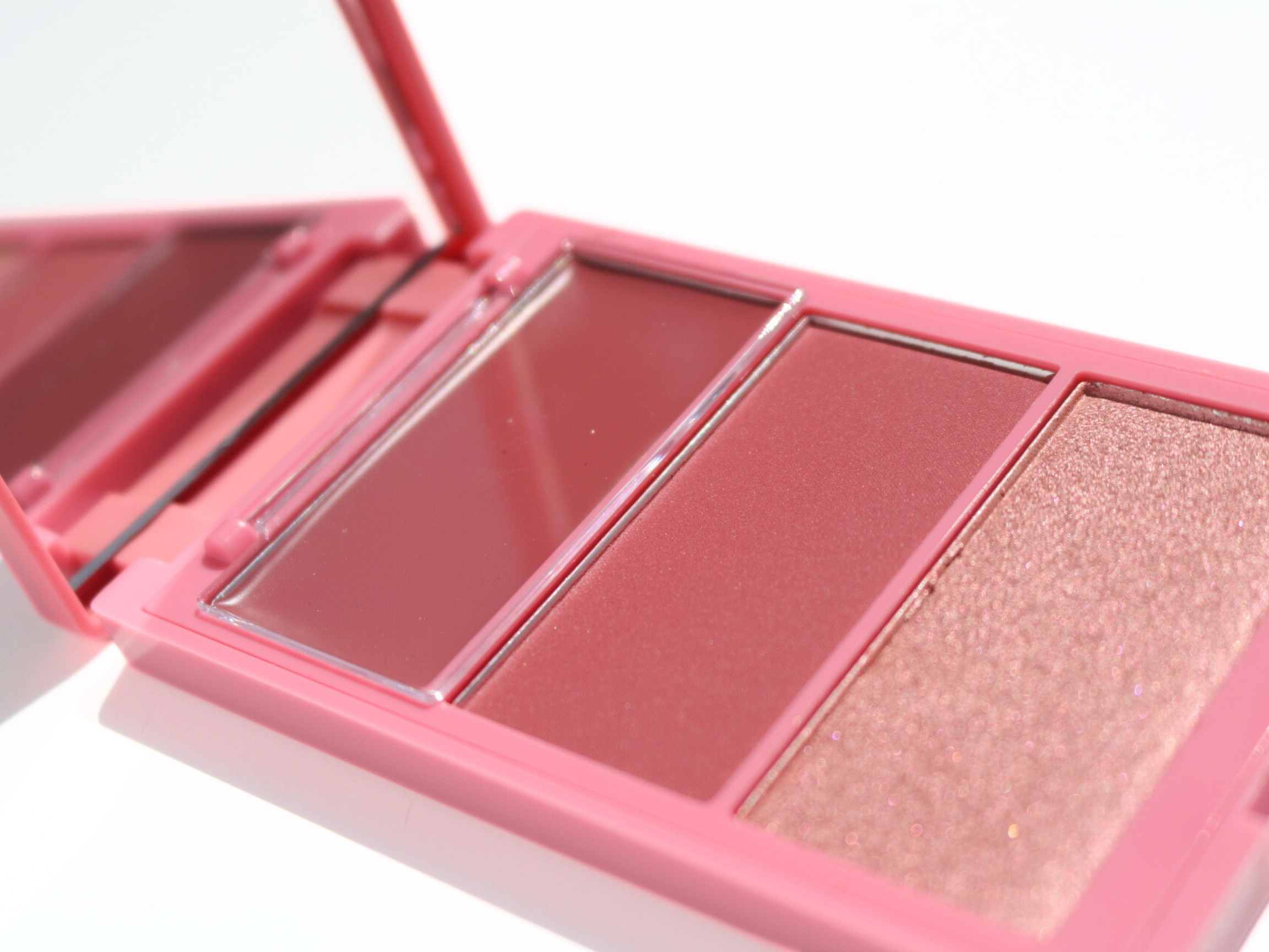 Cheek palette with three shades of mauve/pink on a white background