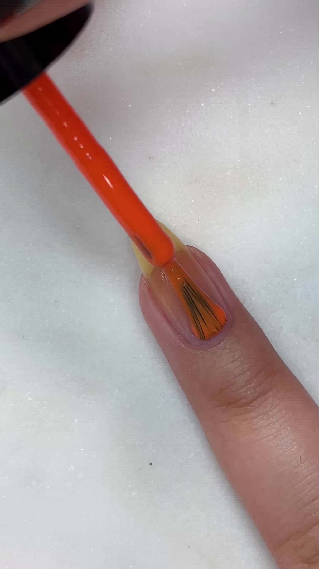 video of fair skin hand model painting nails with nail lacquer showing smooth application and finished product