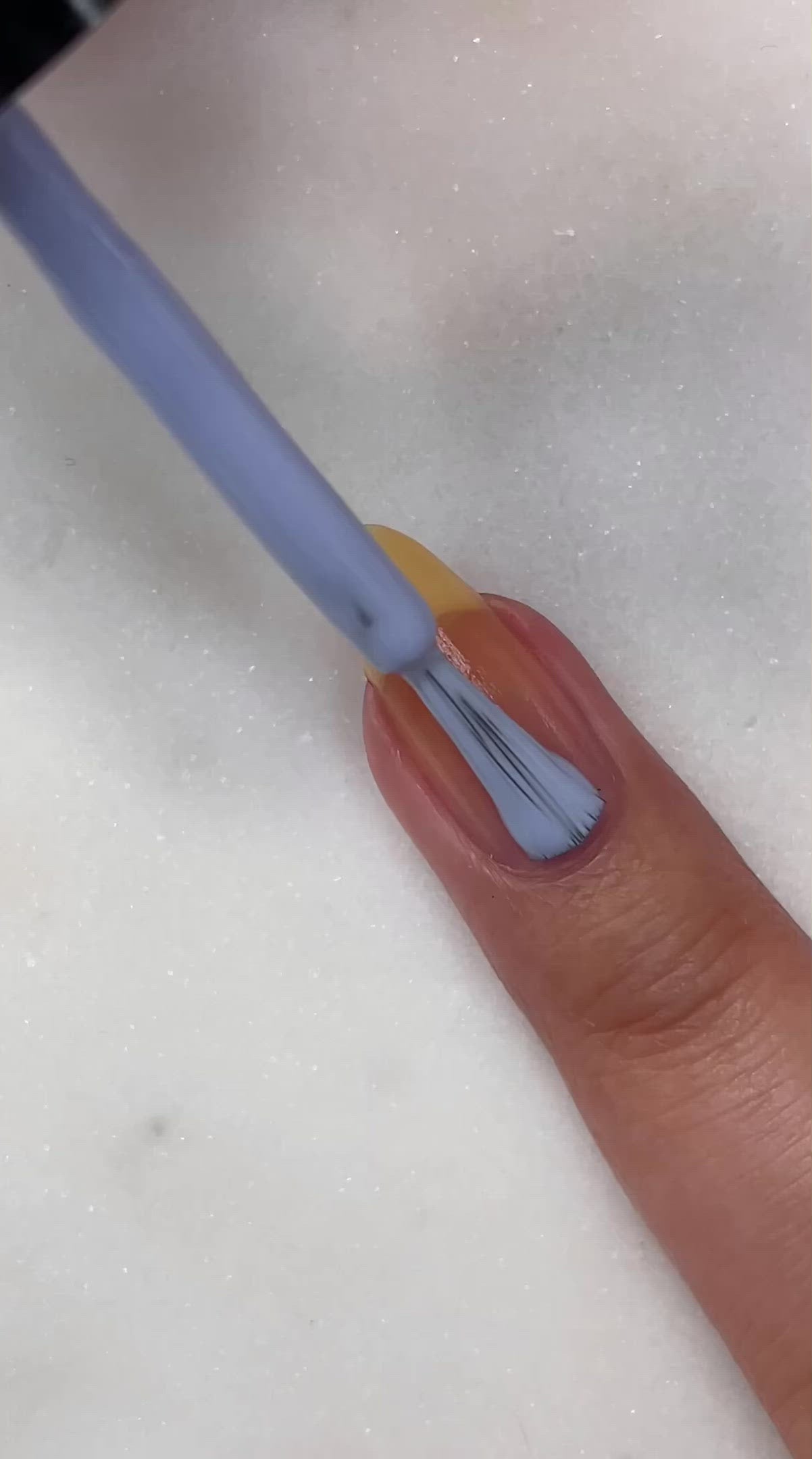 video of fair skin hand model painting nails with nail lacquer showing smooth application and finished product