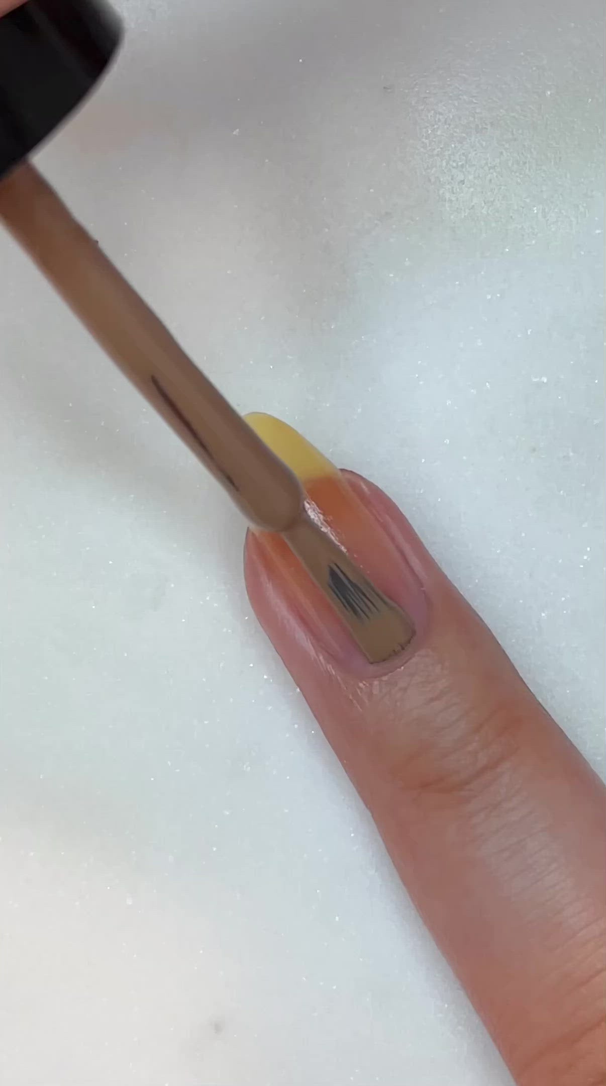 video of fair skin hand model painting nails with nail lacquer showing smooth application and finished product