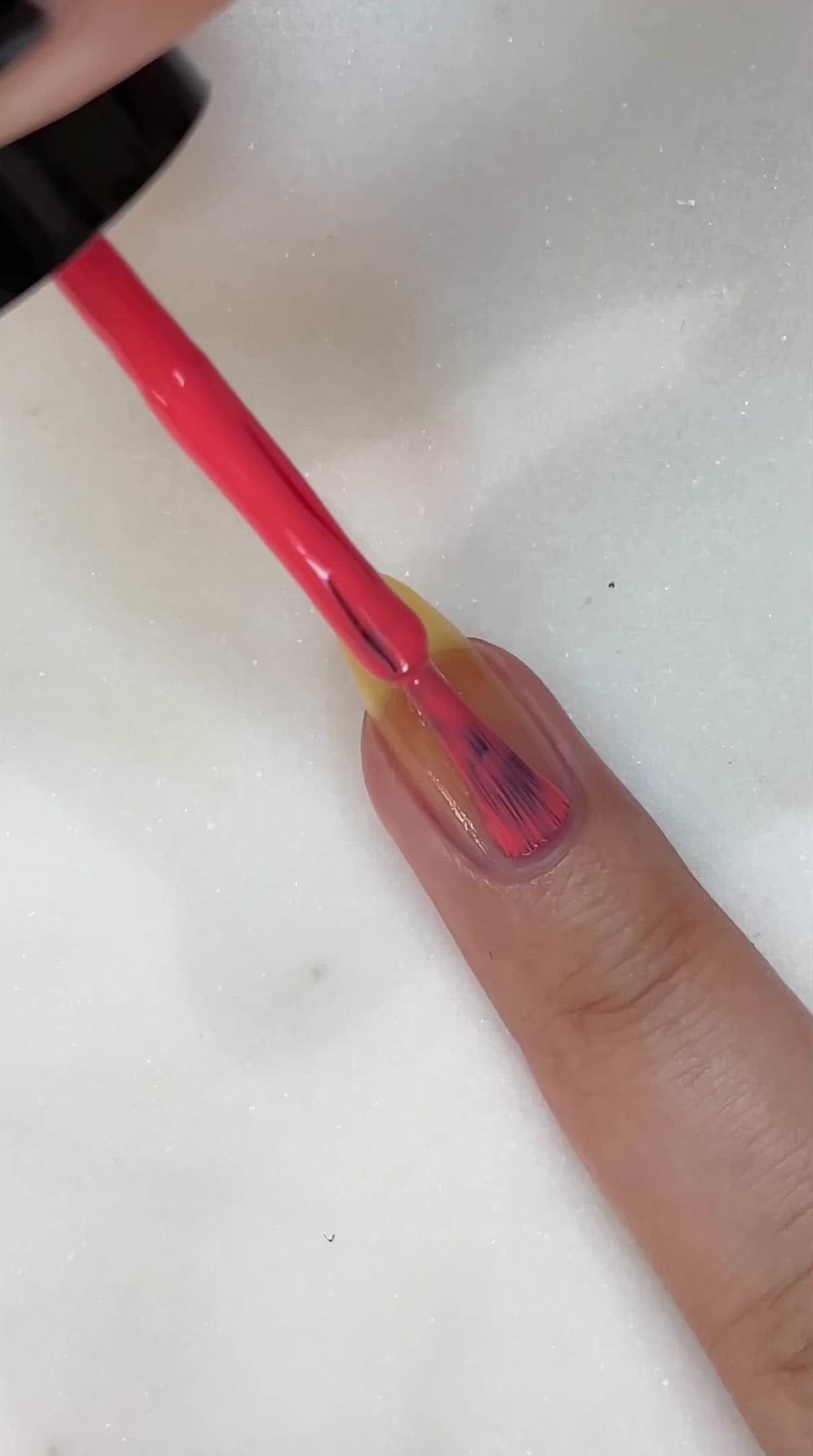 video of fair skin hand model painting nails with nail lacquer showing smooth application and finished product