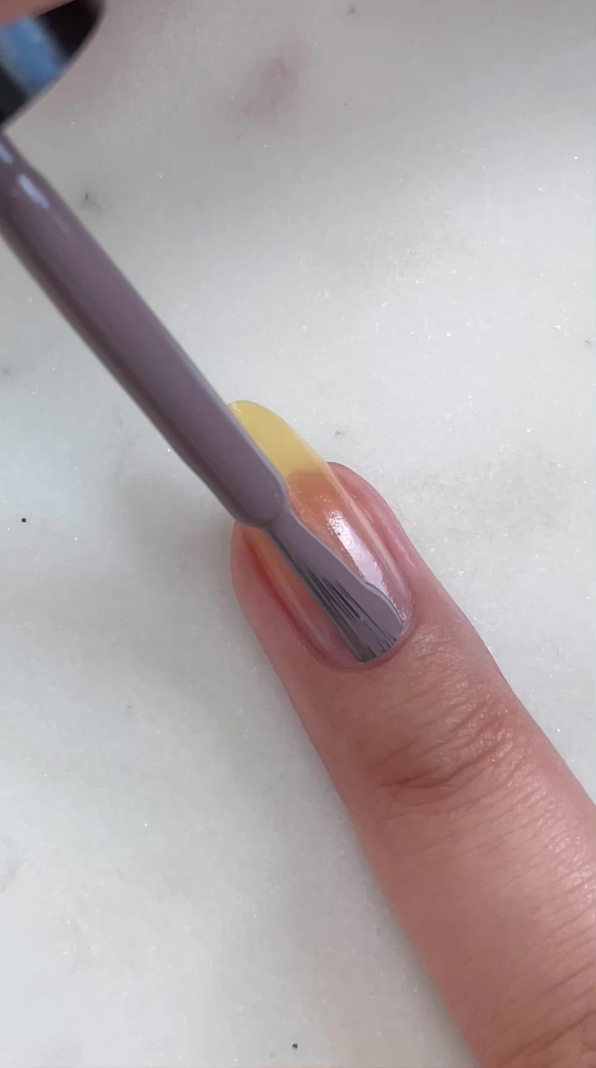 video of fair skin hand model painting nails with nail lacquer showing smooth application and finished product