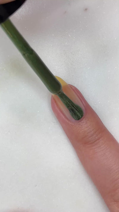 video of fair skin hand model painting nails with nail lacquer showing smooth application and finished product