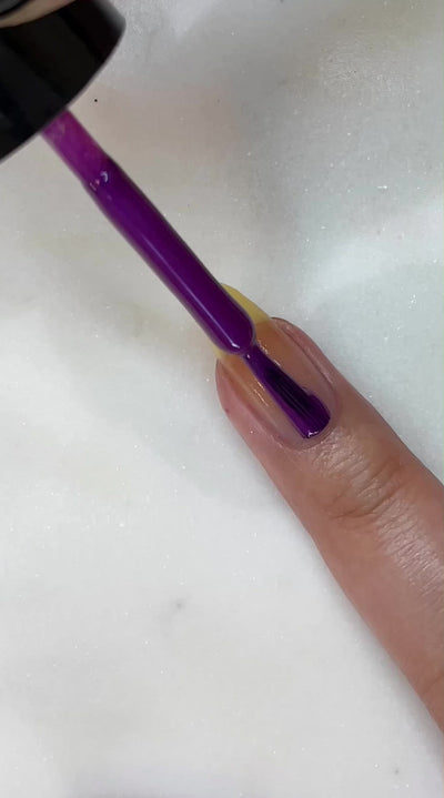video of fair skin hand model painting nails with nail lacquer showing smooth application and finished product