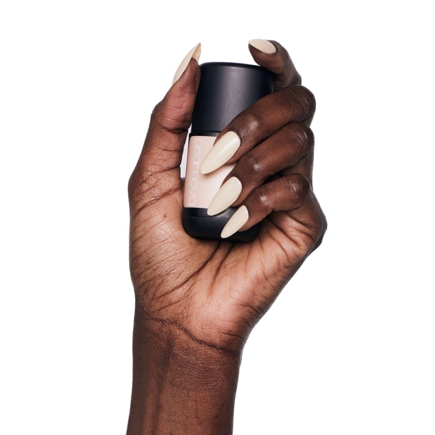 brown skin hand model holding bottle of nail lacquer with almond shaped painted nails 