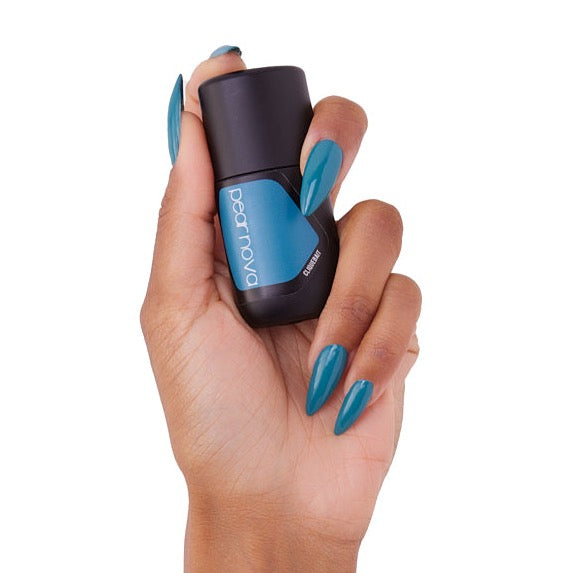 brown skin hand model holding bottle of nail lacquer with almond shaped turquoise painted nails in Cliquebait 